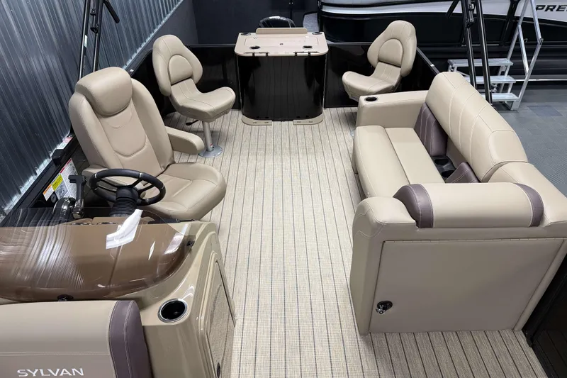 Slide: The Image of 2026 Sylvan Mirage 8520 Party Fish pontoon boat interior with beige seating and steering console. - 15