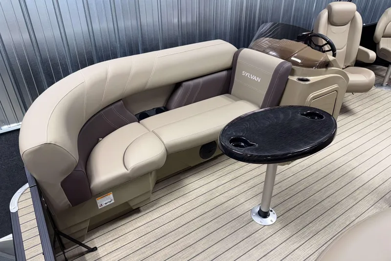 Slide: The Image of 2026 Sylvan Mirage 8520 Party Fish boat interior with plush seating and sleek table design. - 18