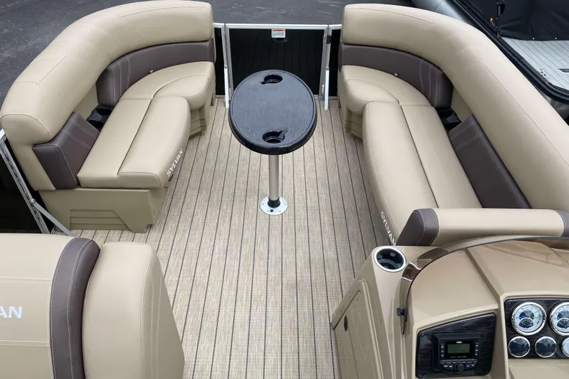 Slide: The Image of 2026 Sylvan Mirage 8520 Party Fish pontoon boat interior with beige seating and helm. - 2
