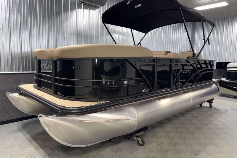 Slide: The Image of 2026 Sylvan Mirage 8520 Party Fish pontoon boat in showroom, featuring sleek design and canopy. - 20