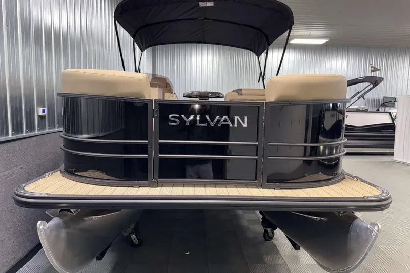 Slide: The Image of 2026 Sylvan Mirage 8520 Party Fish pontoon boat in showroom, featuring sleek black design. - 21