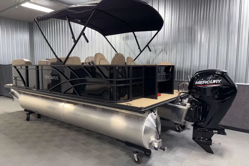 Slide: The Image of 2026 Sylvan Mirage 8520 Party Fish pontoon boat with Mercury outboard motor in a showroom. - 25