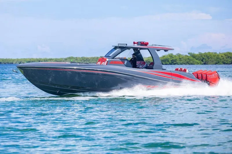 Slide: The Image of 2022 Deep Impact 399 Sport boat cruising on clear blue water. - 12