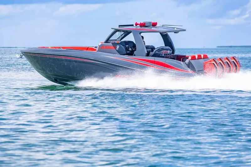 Slide: The Image of 2022 Deep Impact 399 Sport boat cruising on open water, showcasing sleek design and powerful engines. - 13