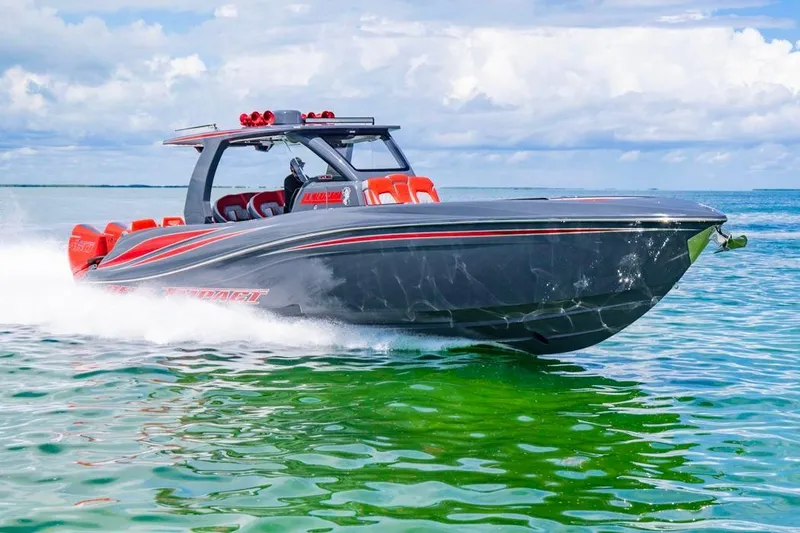 Slide: The Image of 2022 Deep Impact 399 Sport boat cruising on clear blue water. - 16