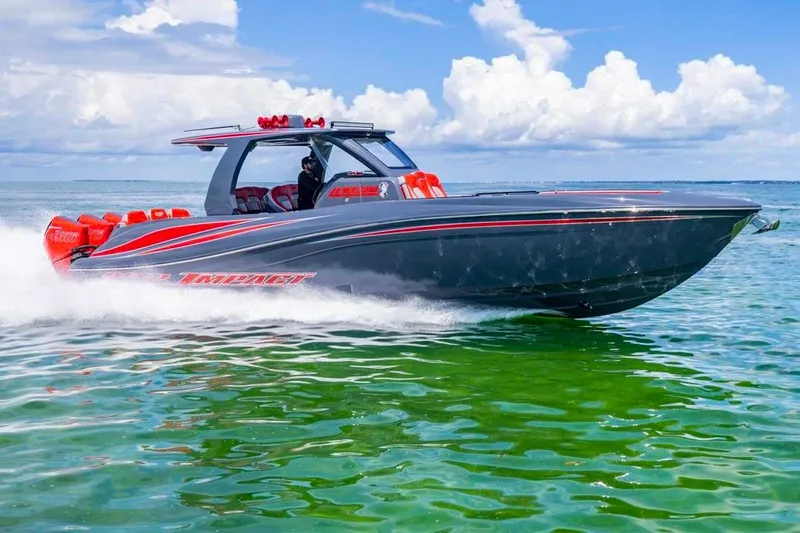 Slide: The Image of 2022 Deep Impact 399 Sport boat cruising on clear green water under a blue sky. - 17