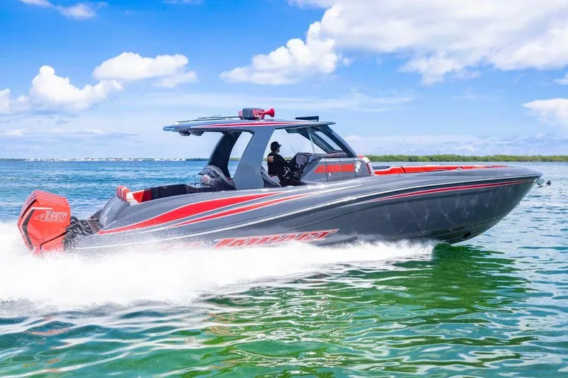 Slide: The Image of 2022 Deep Impact 399 Sport boat cruising on clear blue water under a sunny sky. - 18