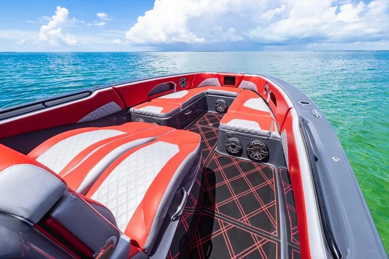 Slide: The Image of 2022 Deep Impact 399 Sport boat interior with red and white seating on open water. - 23
