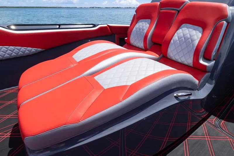 Slide: The Image of Luxurious red and white seating on 2022 Deep Impact 399 Sport boat, ocean backdrop. - 27