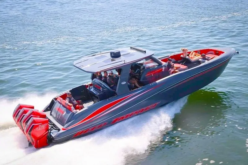 Slide: The Image of 2022 Deep Impact 399 Sport boat on clear blue water, featuring sleek design and vibrant seating. - 3