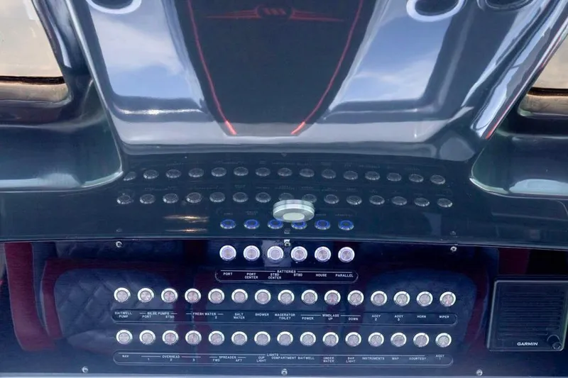 Slide: The Image of Control panel of 2022 Deep Impact 399 Sport boat with multiple switches and buttons. - 39