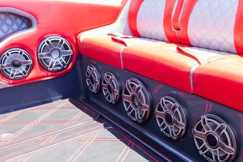 Slide: The Image of Red and white interior of 2022 Deep Impact 399 Sport boat with multiple speakers. - 43