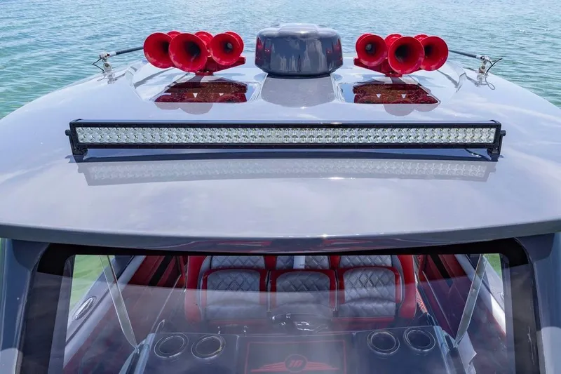 Slide: The Image of 2022 Deep Impact 399 Sport boat with red horns and LED light bar on the roof. - 46