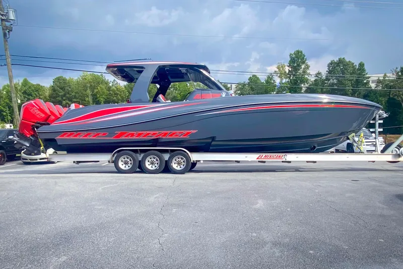 Slide: The Image of 2022 Deep Impact 399 Sport boat on trailer, featuring sleek design and vibrant red accents. - 47
