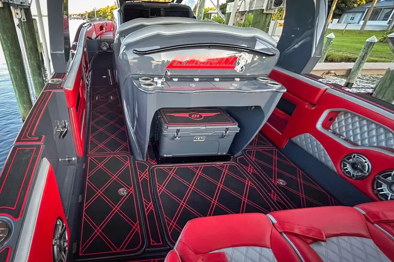 Slide: The Image of 2022 Deep Impact 399 Sport boat cruising on clear blue water. - 5