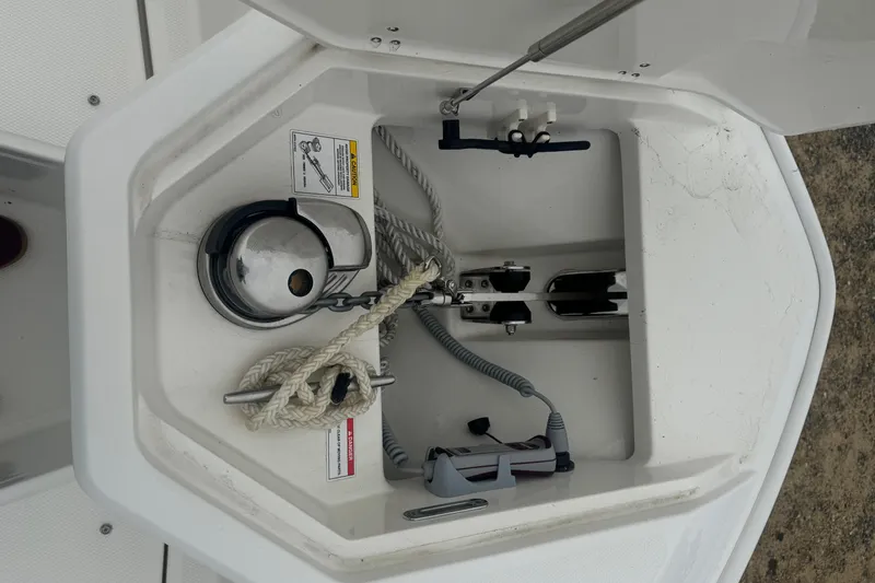 Slide: The Image of Anchor compartment of 2023 Boston Whaler 280 Dauntless boat with rope and winch. - 18