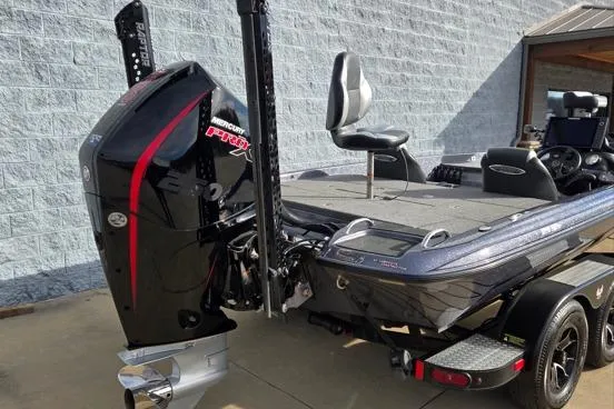 Slide: The Image of 2023 Phoenix 920 Elite fishing boat with powerful outboard motor, parked on trailer. - 10