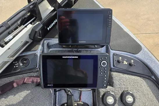 Slide: The Image of 2023 Phoenix 920 Elite boat dashboard with Garmin and Humminbird navigation displays. - 3