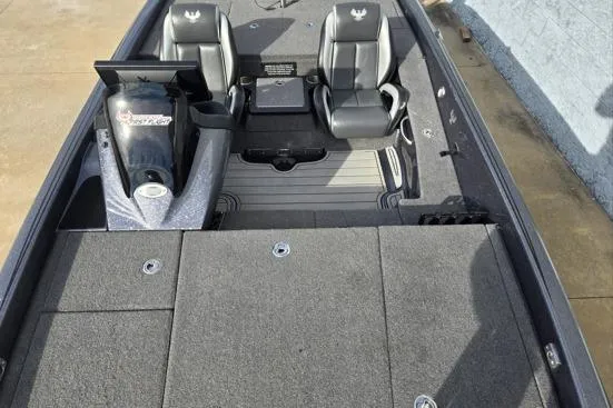 Slide: The Image of 2023 Phoenix 920 Elite boat interior with dual seats and motor, showcasing spacious design. - 4