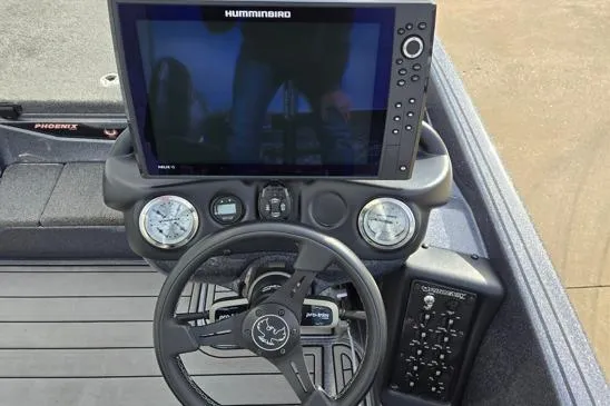 Slide: The Image of 2023 Phoenix 920 Elite boat dashboard with Humminbird display and steering wheel. - 6