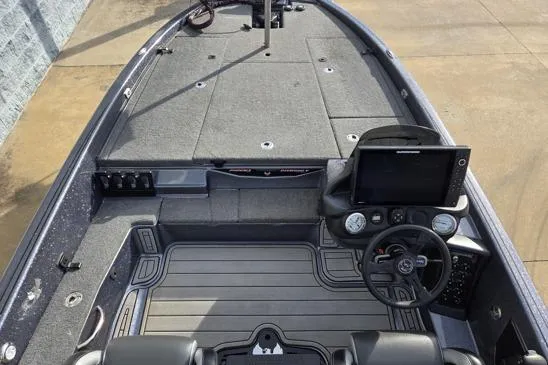 Slide: The Image of 2023 Phoenix 920 Elite boat interior with advanced dashboard and spacious deck layout. - 7