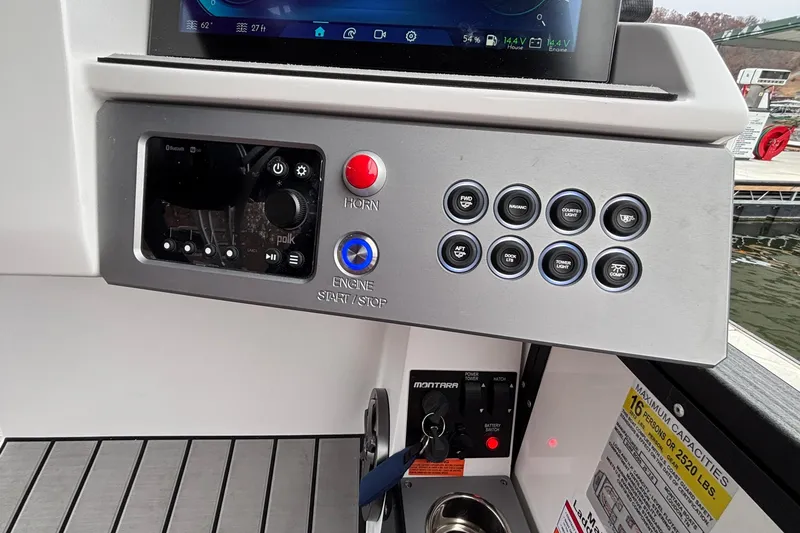 Slide: The Image of Control panel of 2025 Montara 25 Surf Boss boat with various buttons and switches. - 11