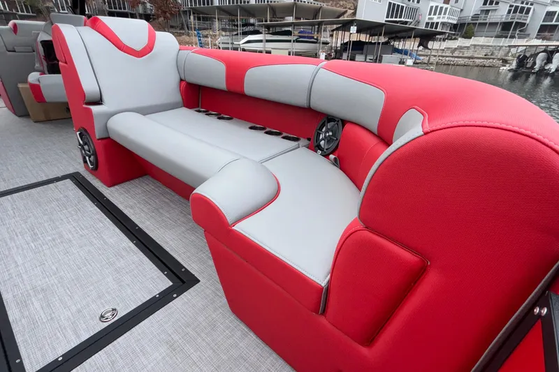 Slide: The Image of Red and gray seating on 2025 Montara 25 Surf Boss boat, featuring cup holders and speakers. - 28
