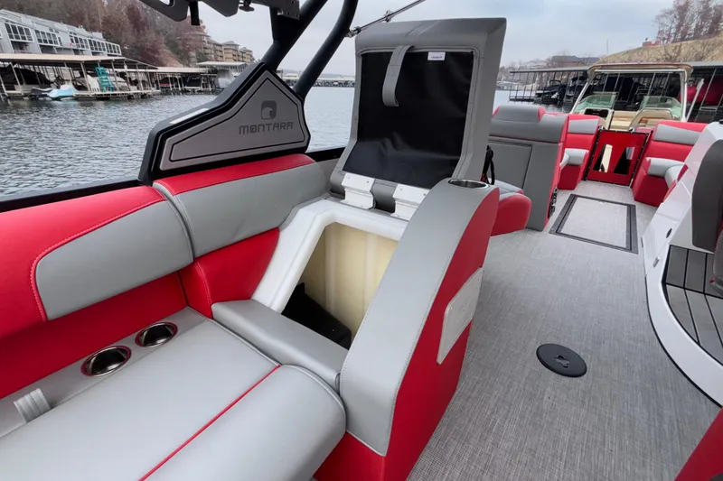 Slide: The Image of 2025 Montara 25 Surf Boss boat interior with red and gray seating, open storage compartment. - 33