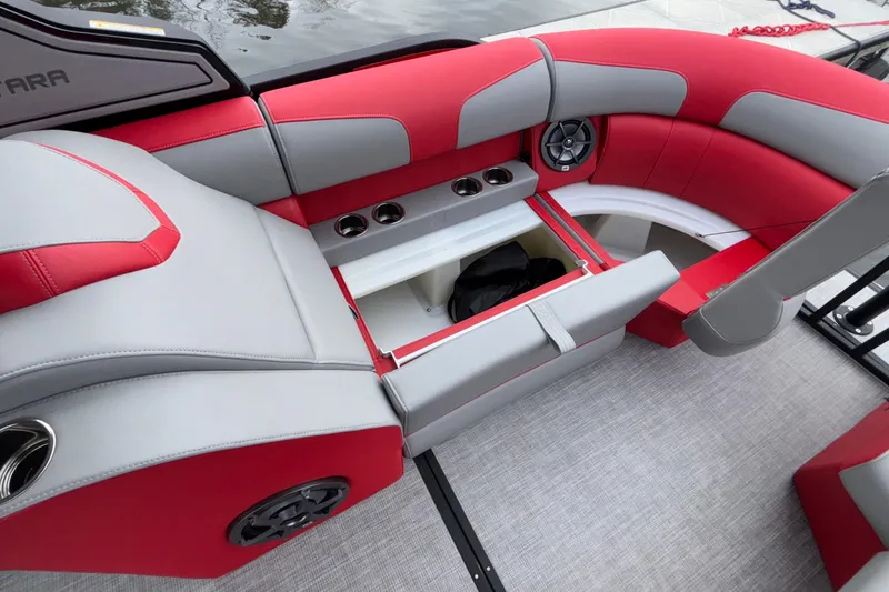 Slide: The Image of 2025 Montara 25 Surf Boss boat interior with red and gray seating, storage, and speakers. - 35