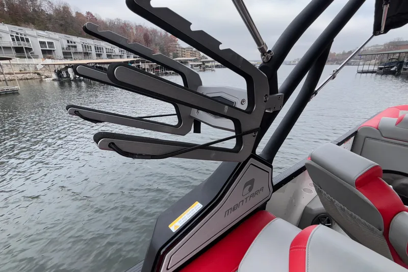 Slide: The Image of 2025 Montara 25 Surf Boss boat with sleek design and modern features on a calm lake. - 38