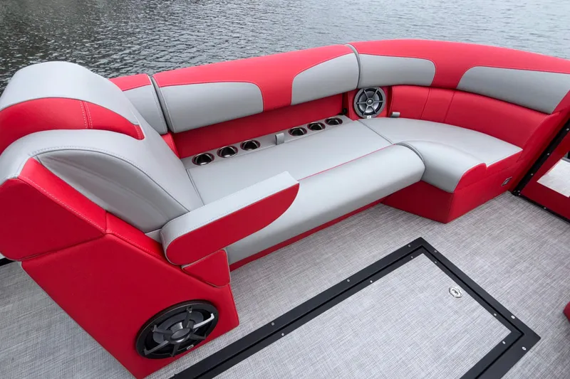 Slide: The Image of 2025 Montara 25 Surf Boss boat interior with red and gray seating, cup holders, and speakers. - 42