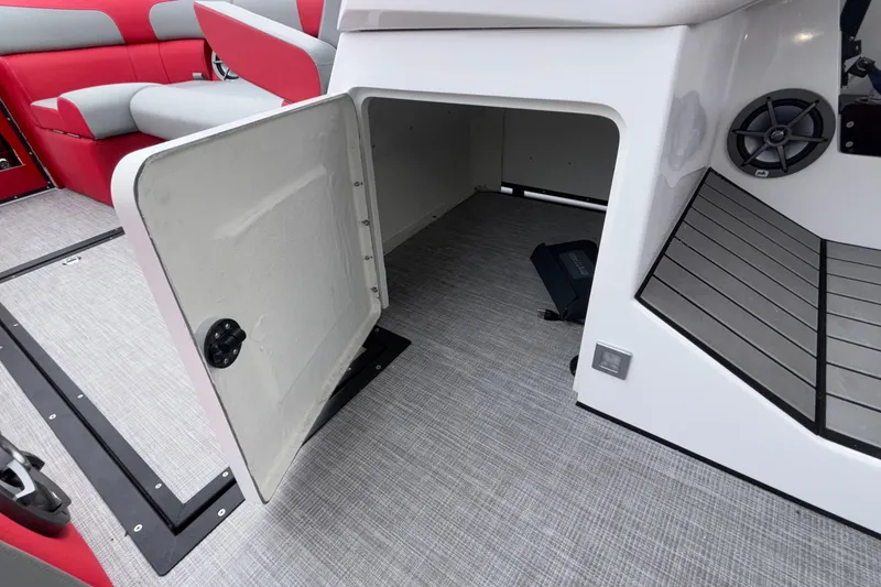 Slide: The Image of 2025 Montara 25 Surf Boss interior storage compartment with open door and seating area. - 45