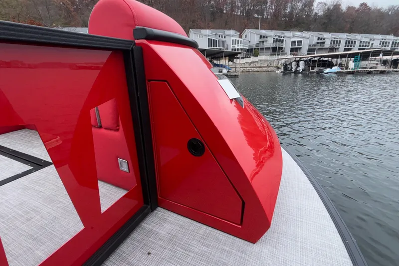 Slide: The Image of 2025 Montara 25 Surf Boss boat with sleek red design docked by waterfront homes. - 46