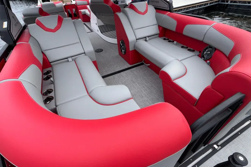 Slide: The Image of 2025 Montara 25 Surf Boss boat interior with red and gray seating, cup holders, and modern design. - 51