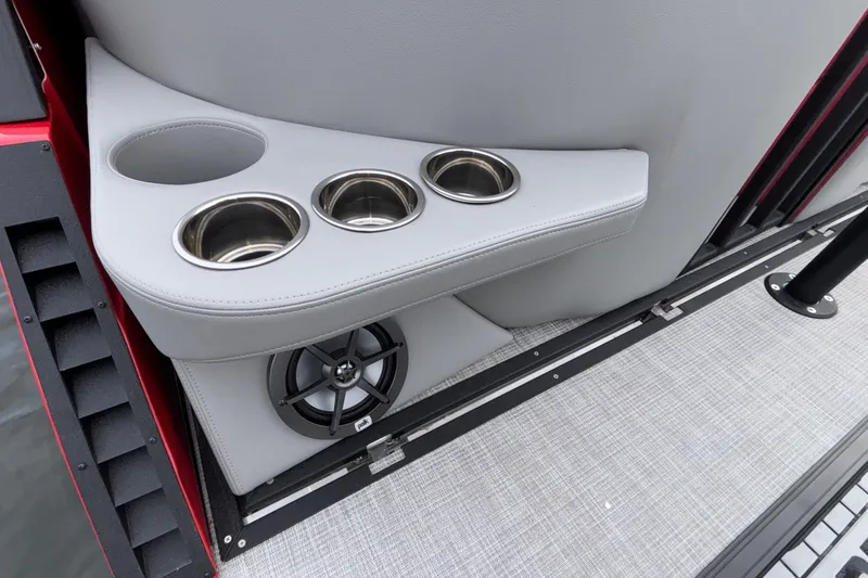 Slide: The Image of 2025 Montara 25 Surf Boss boat interior with cup holders and speaker. - 52