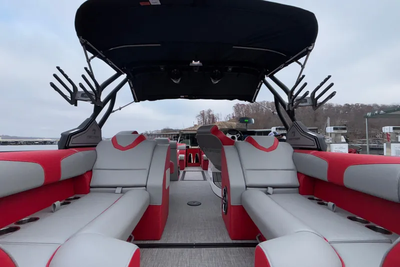 Slide: The Image of 2025 Montara 25 Surf Boss boat interior with red and gray seating, sleek design. - 53