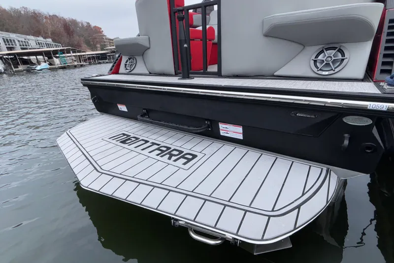 Slide: The Image of 2025 Montara 25 Surf Boss boat with swim platform on a lake. - 55
