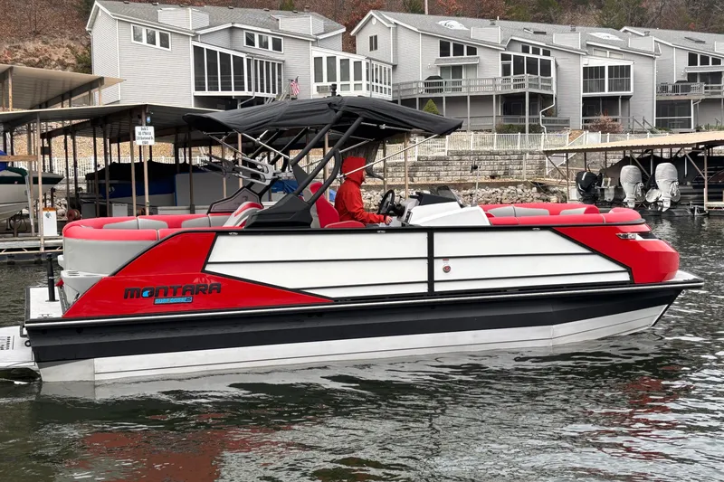 Slide: The Image of 2025 Montara 25 Surf Boss boat docked near modern waterfront homes. - 57