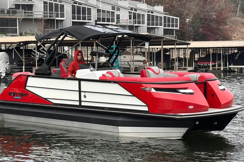 Slide: The Image of 2025 Montara 25 Surf Boss boat in water, featuring red and white design. - 58