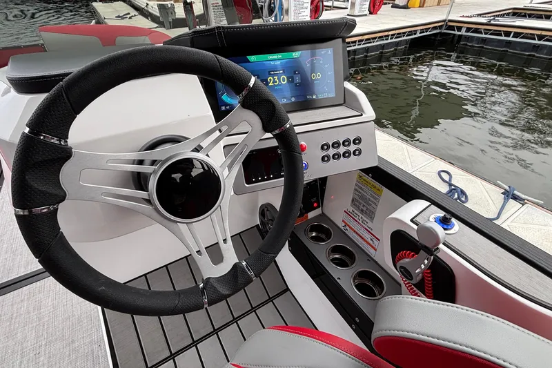 Slide: The Image of 2025 Montara 25 Surf Boss boat dashboard with steering wheel and digital display. - 9