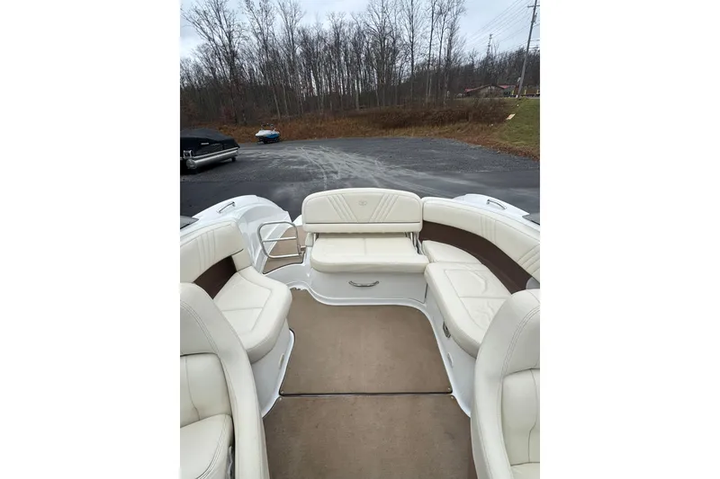 Slide: The Image of Interior view of 2009 Cobalt 242 boat with white leather seating and carpeted floor. - 13