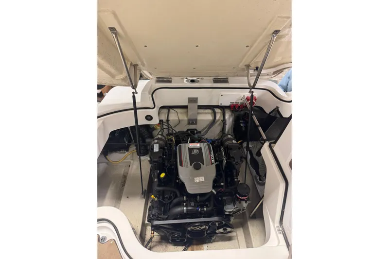 Slide: The Image of 2009 Cobalt 242 boat engine compartment with open hatch, showcasing engine details. - 14