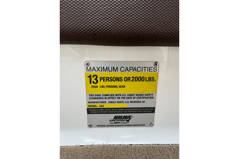 Slide: The Image of 2009 Cobalt 242 capacity plate: 13 persons or 2000 lbs, US Coast Guard compliant. - 16