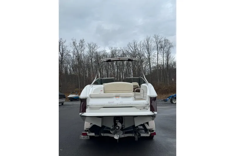 Slide: The Image of 2009 Cobalt 242 boat, rear view, parked outdoors on a cloudy day. - 6