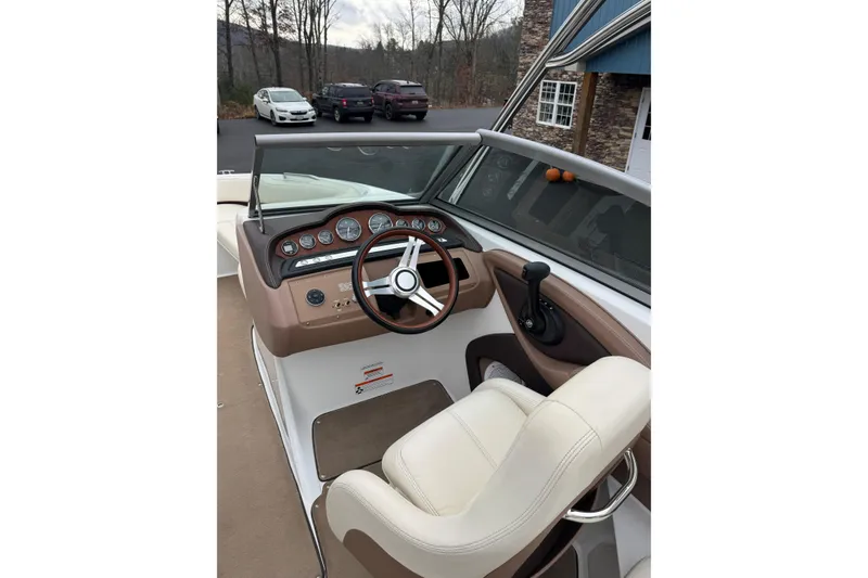 Slide: The Image of 2009 Cobalt 242 boat interior with steering wheel and dashboard controls. - 9
