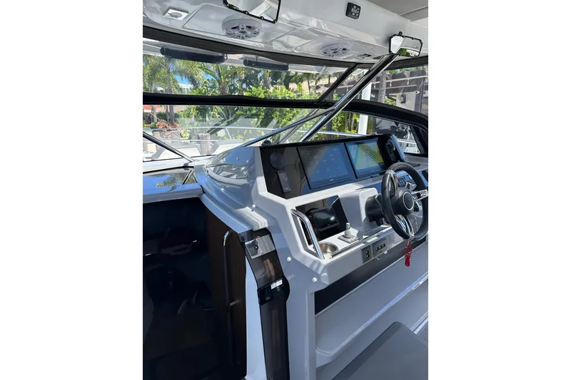 Slide: The Image of 2022 Jeanneau Leader 12.5 WA cockpit with modern navigation system and steering wheel. - 13