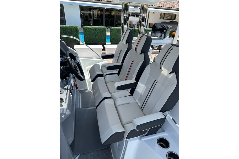 Slide: The Image of 2022 Jeanneau Leader 12.5 WA boat cockpit with modern seating and steering wheel. - 14