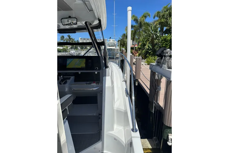 Slide: The Image of 2022 Jeanneau Leader 12.5 WA docked, showcasing sleek design and modern cockpit. - 19