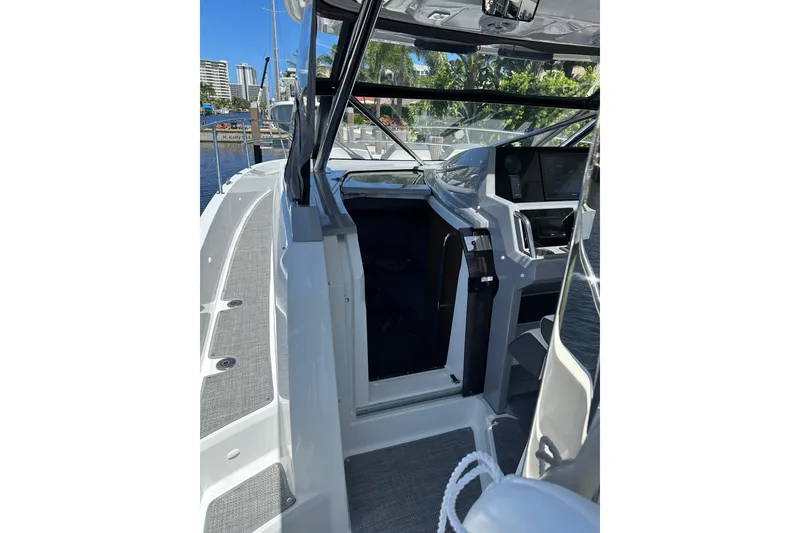 Slide: The Image of 2022 Jeanneau Leader 12.5 WA boat interior with helm and open cabin door. - 24