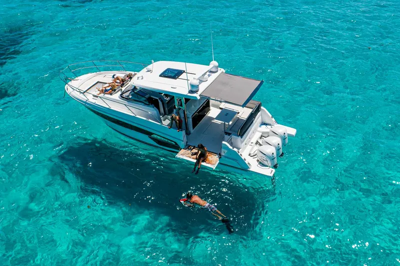 Slide: The Image of Manufacturer Provided Image: 2022 Jeanneau Leader 12.5 WA boat in clear blue water with people swimming. - 3